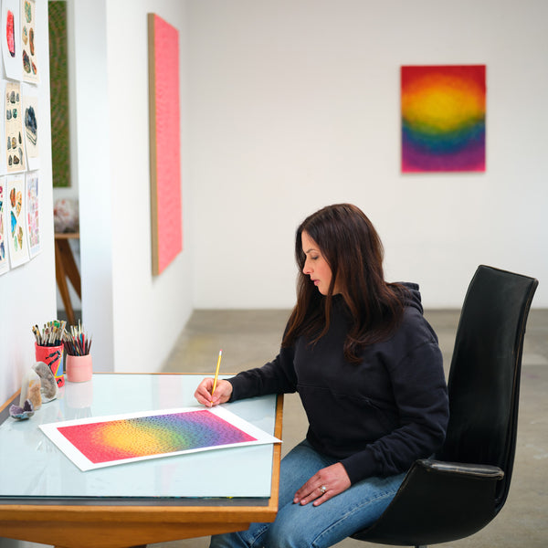 Image of Jennifer Guidi in her studio featuring the Rainbow Orb 2 print