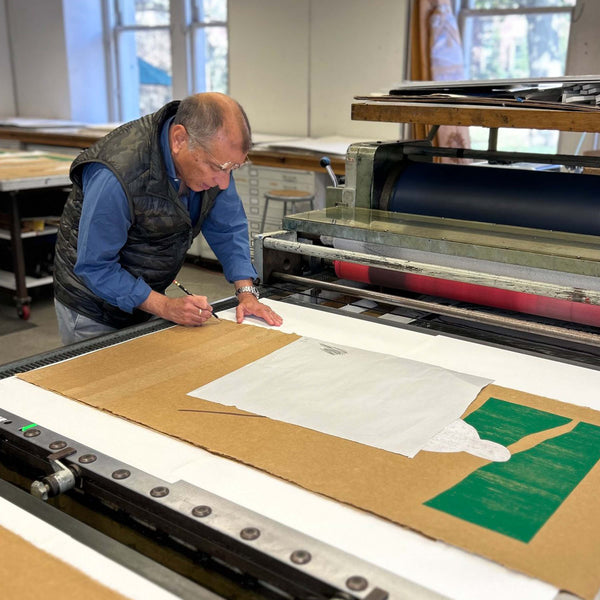 Image of Y.Z. Kami signing the Messenger print