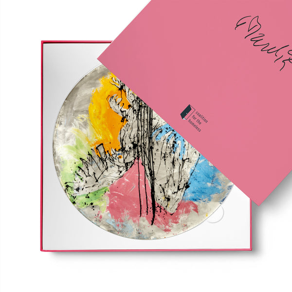 Dinner plate featuring artwork by Georg Baselitz in a box