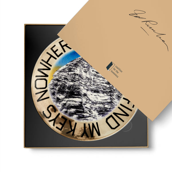 Dinner plate featuring artwork by Ed Ruscha in a box